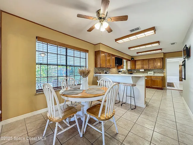 a bathroom with a granite countertop toilet a mirror and shower