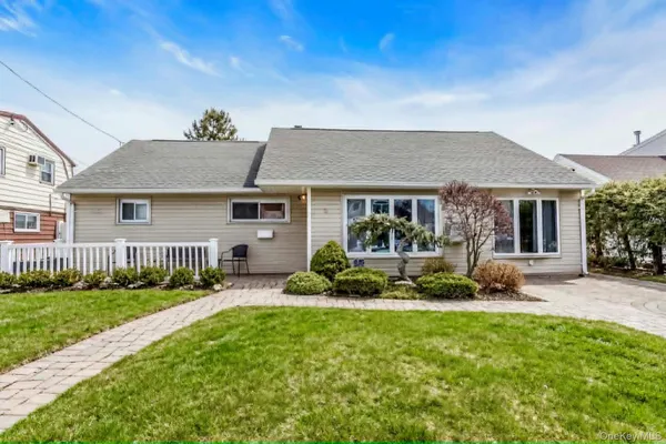 a front view of a house with a yard and outdoor seating