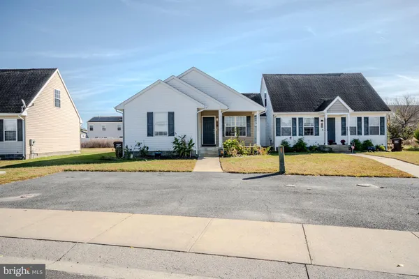 a view of house with a yard and plants