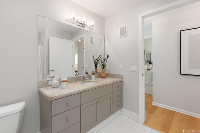 a bathroom with a sink double vanity and a mirror