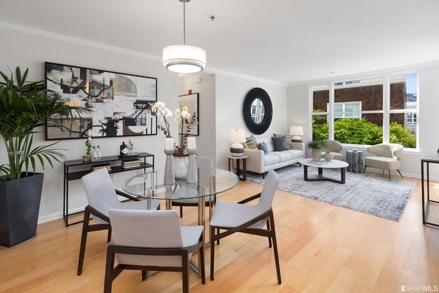 a living room with furniture a window and a clock