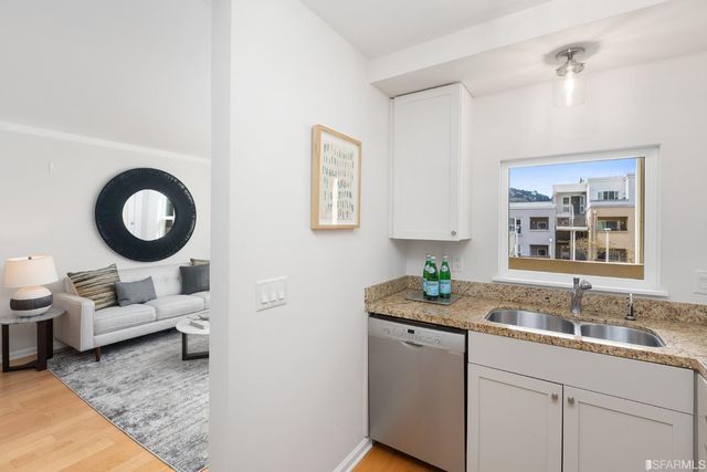a living room with furniture and a sink