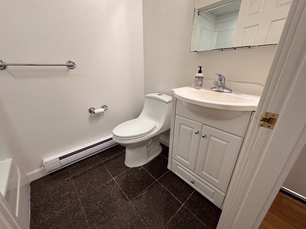 1691 Cambridge Street, Unit 22 Cambridge, MA 02138 - Photo 3 of 17 a bathroom with a sink toilet and vanity