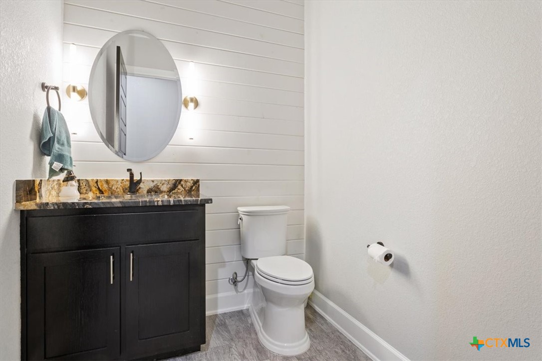 10940 Wedel Cemetery Road Rogers, TX 76569 - Photo 27 of 48 a bathroom with a toilet a sink and mirror
