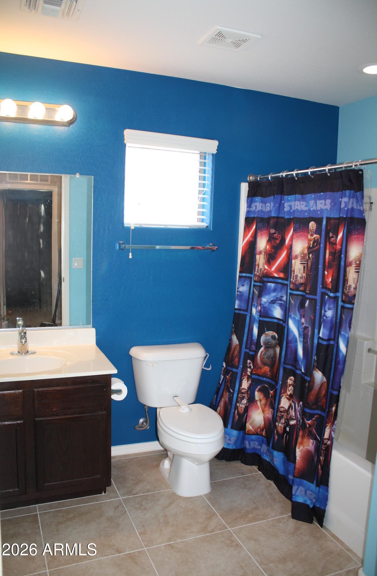 10225 West Camelback Road, Unit 19 Phoenix, AZ 85037 - Photo 27 of 51 a bathroom with a toilet a sink and mirror