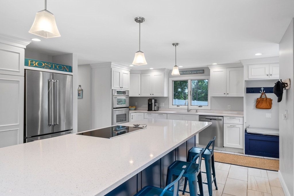 44 Peach Highlands Marblehead, MA 01945 - Photo 11 of 41 a kitchen with stainless steel appliances kitchen island granite countertop a table chairs and a refrigerator