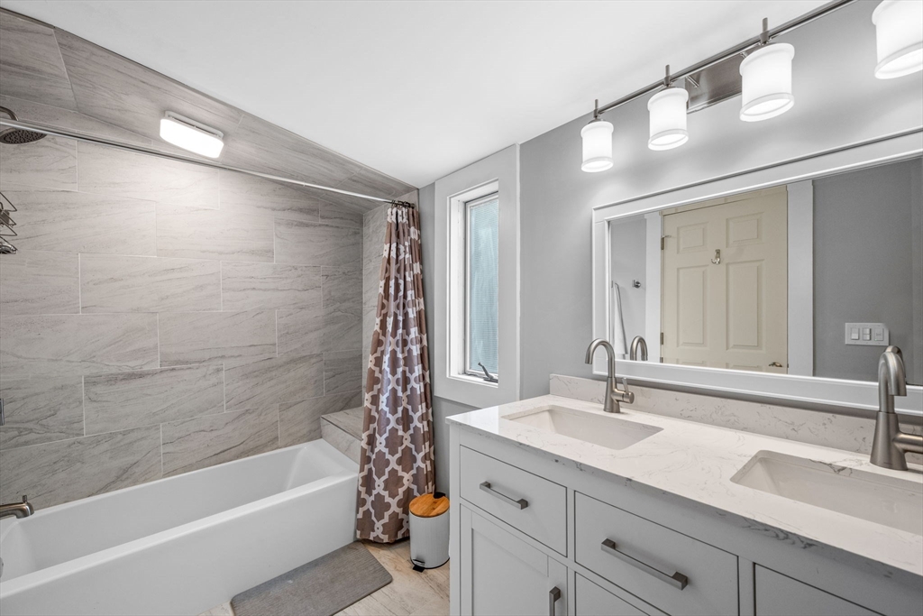 44 Peach Highlands Marblehead, MA 01945 - Photo 24 of 41 a bathroom with a tub a sink and mirror