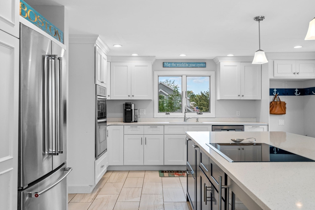 44 Peach Highlands Marblehead, MA 01945 - Photo 10 of 41 a kitchen with a sink dishwasher a refrigerator and white cabinets with wooden floor