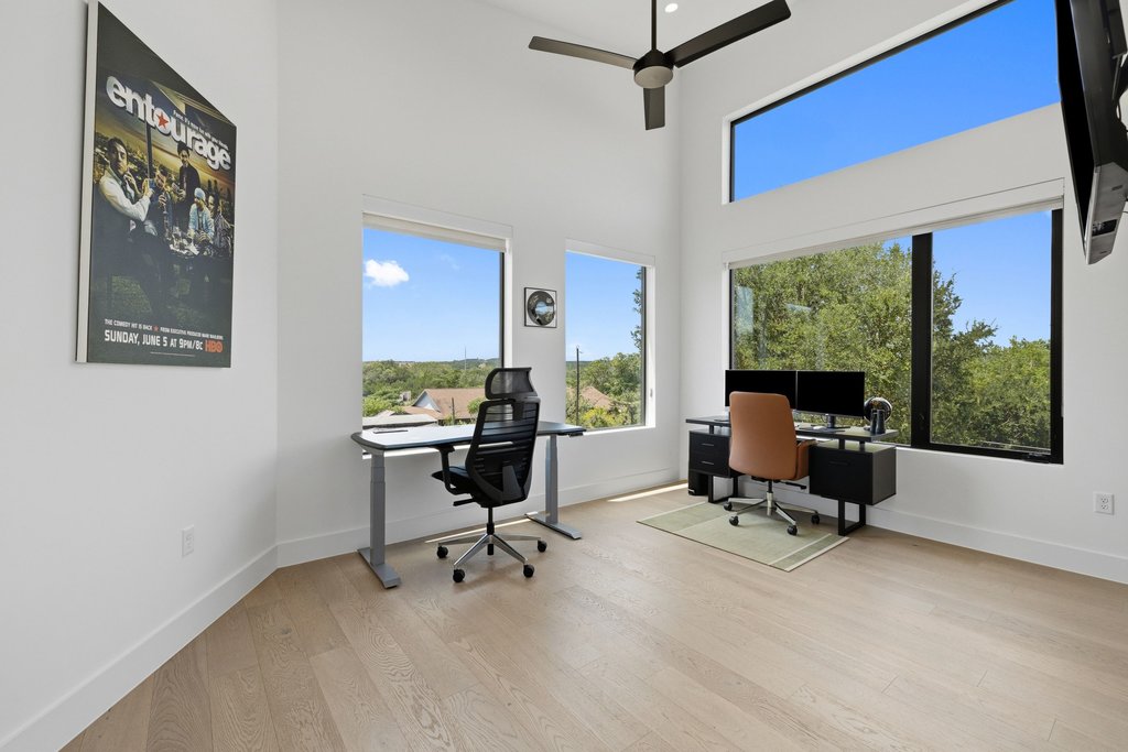 1712 Saracen Road Austin, TX 78733 - Photo 18 of 20 a view of a workspace with furniture and a window