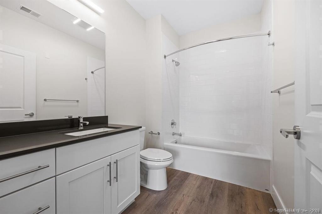 10 A Willard Road, Unit 206 Norwalk, CT 06851 - Photo 25 of 29 a bathroom with a granite countertop sink a toilet and shower
