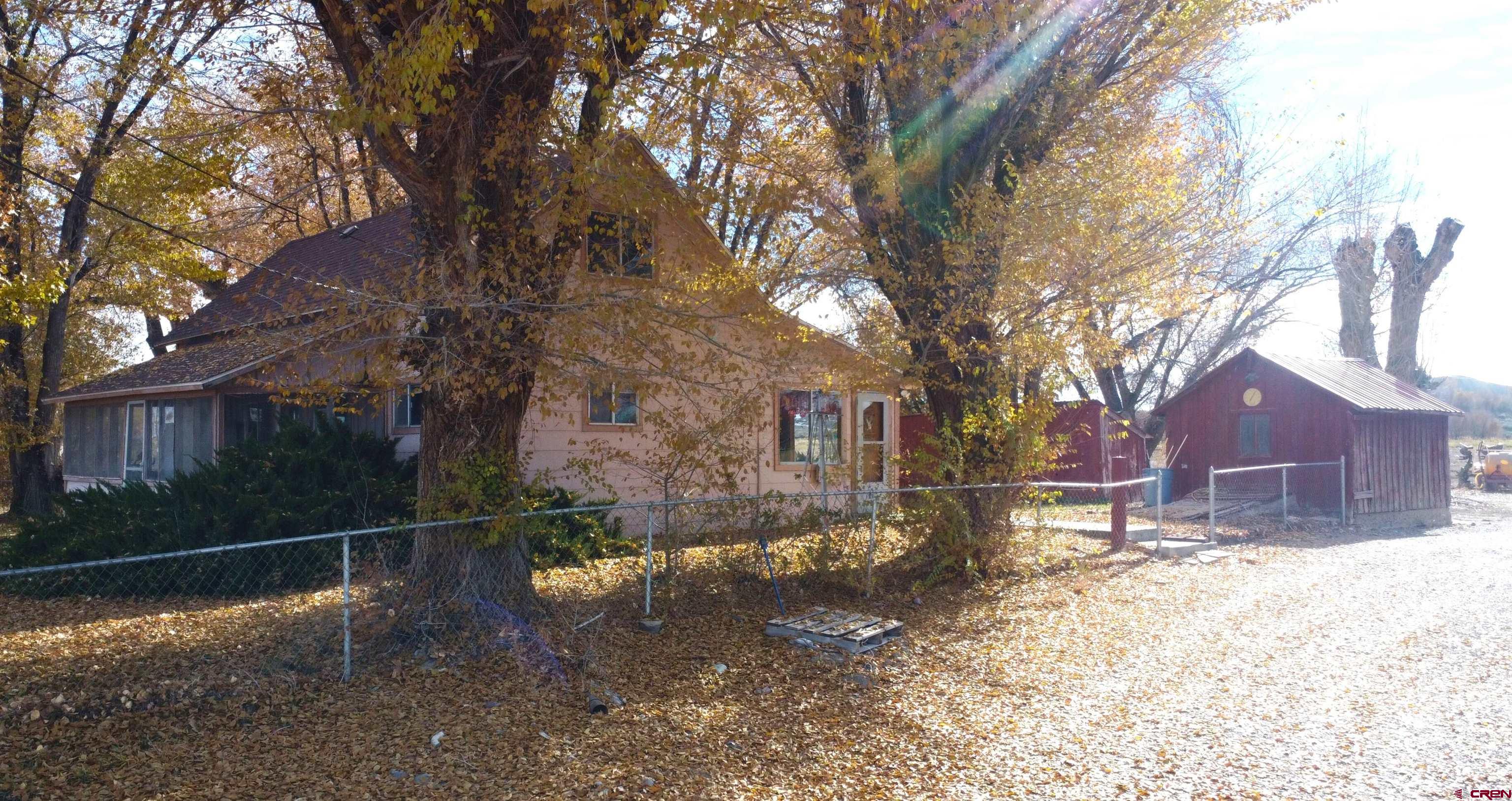 21148 H75 Road Delta, CO 81416 - Photo 1 of 30 a backyard of a house with lots of green space