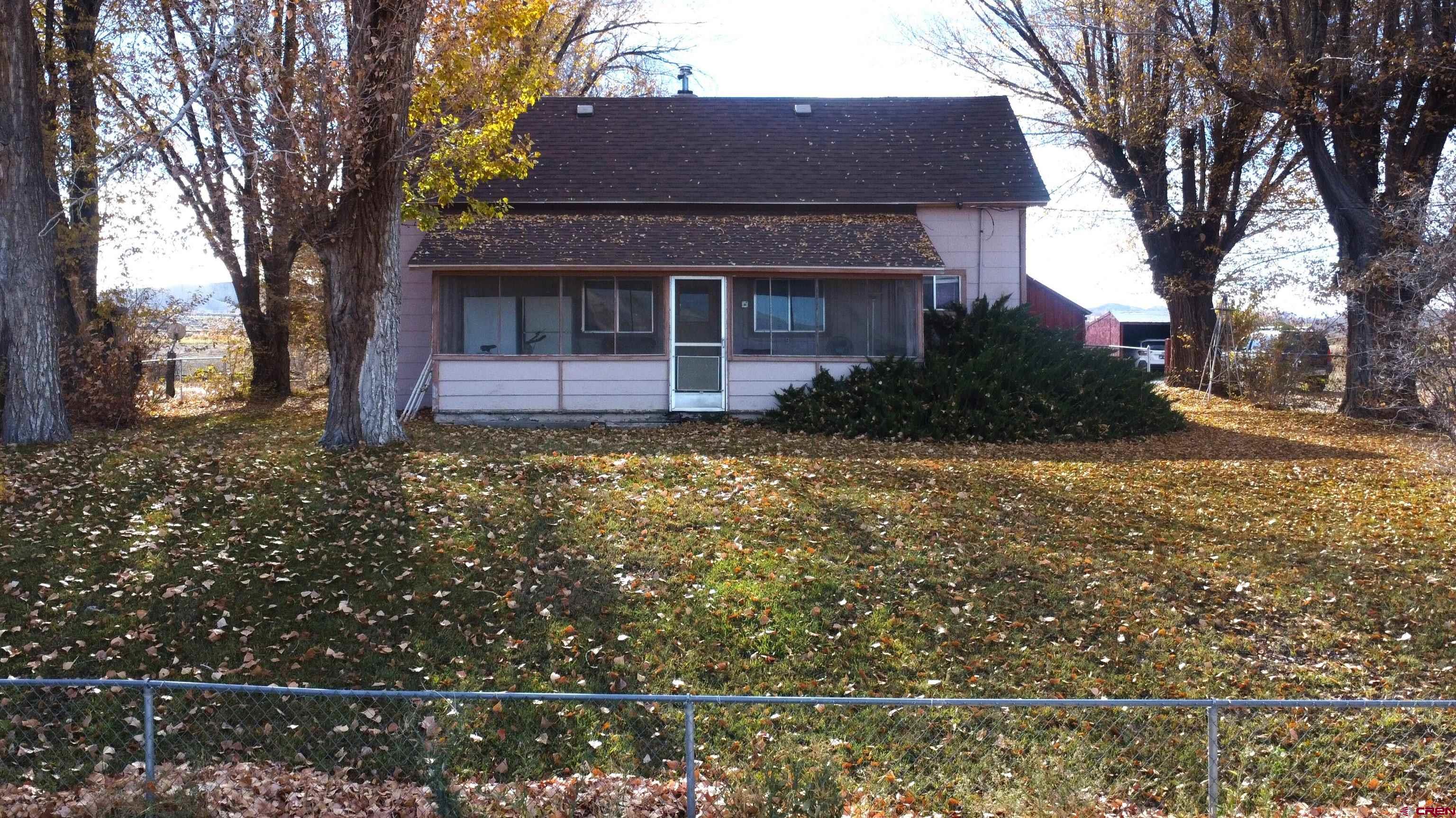 21148 H75 Road Delta, CO 81416 - Photo 2 of 30 a front view of a house with garden
