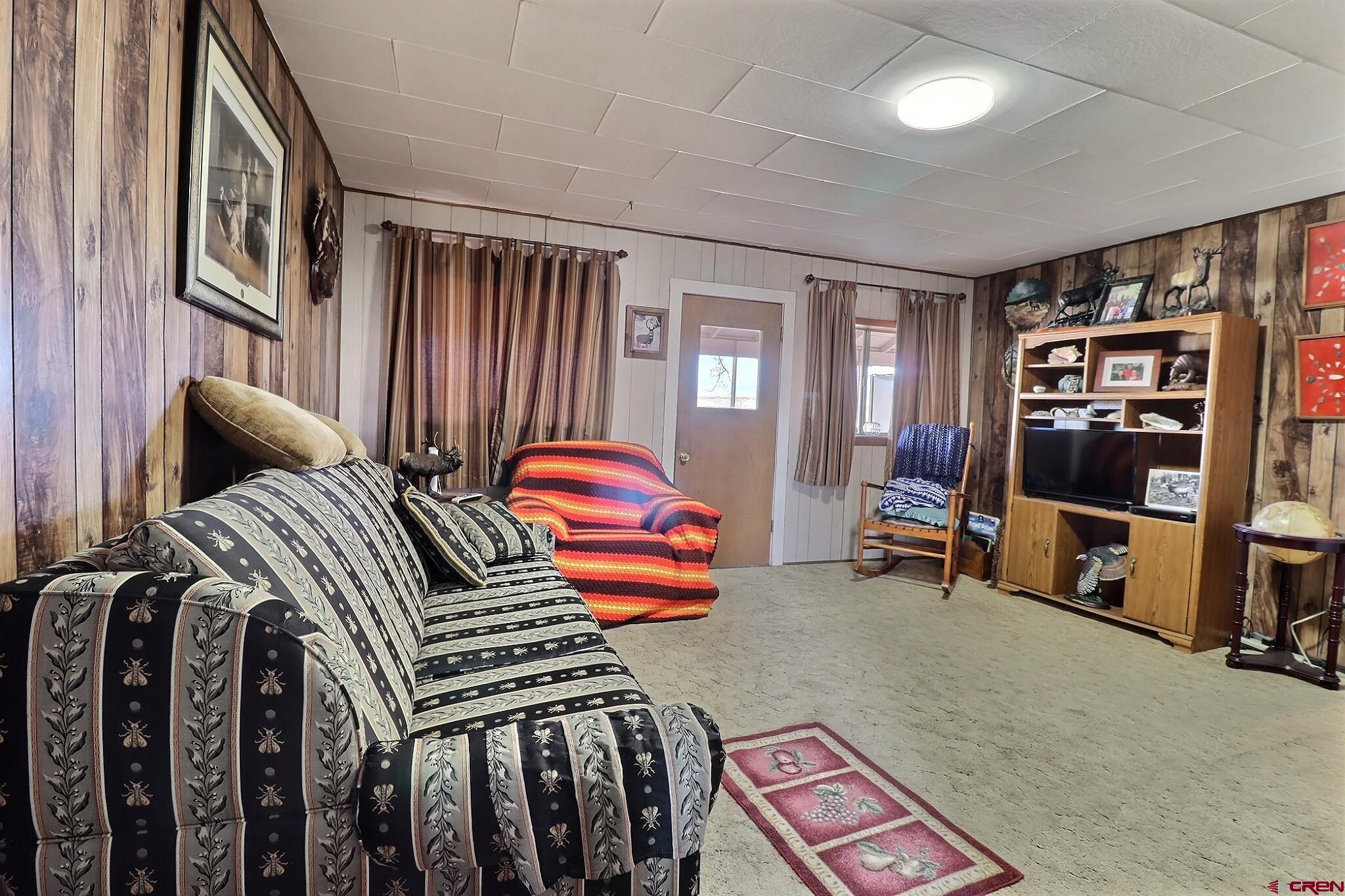 21148 H75 Road Delta, CO 81416 - Photo 22 of 30 a bedroom with furniture and a book shelf