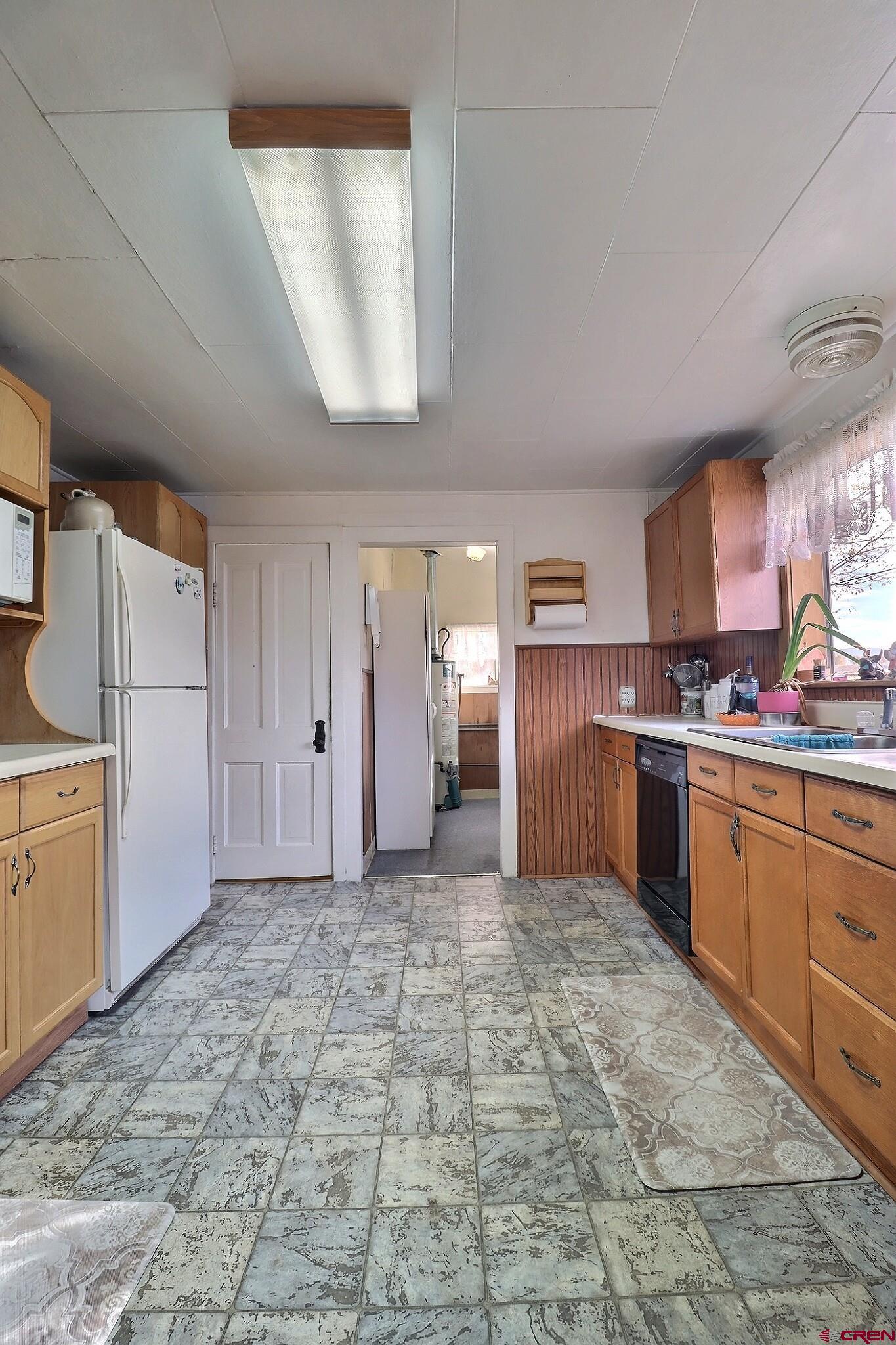 21148 H75 Road Delta, CO 81416 - Photo 26 of 30 a view of a kitchen with refrigerator and cabinets