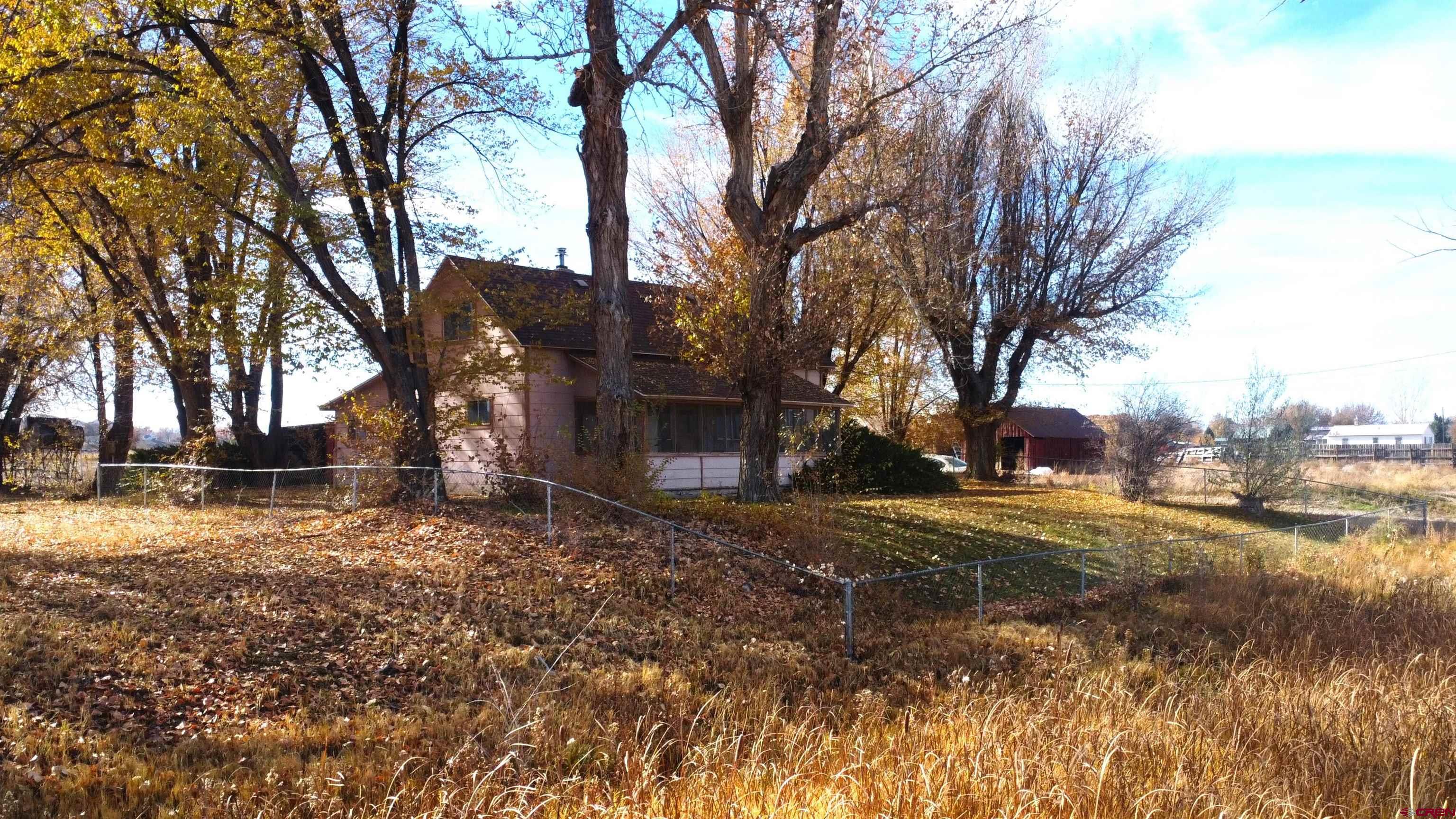 21148 H75 Road Delta, CO 81416 - Photo 3 of 30 a backyard of a house with lots of green space