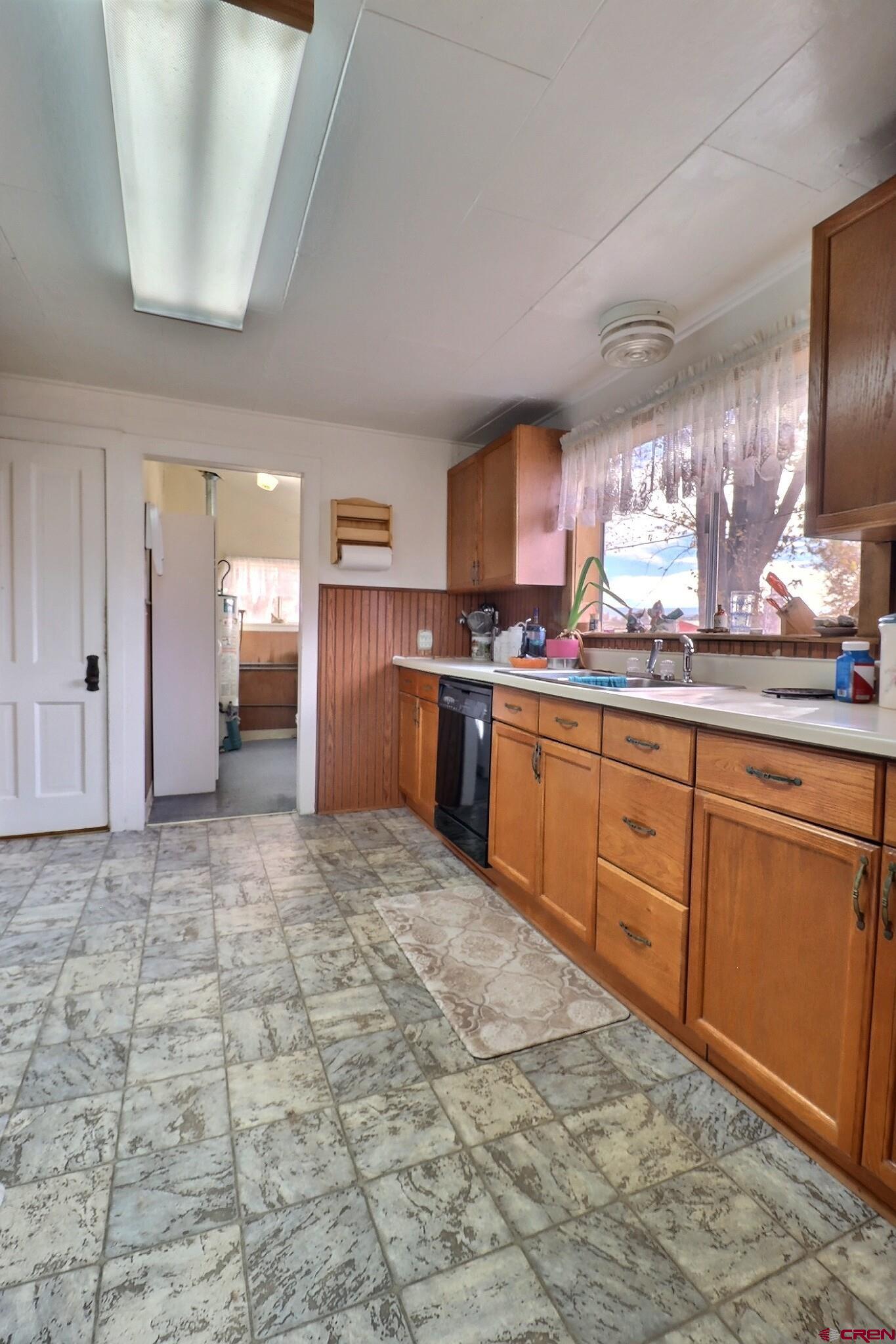 21148 H75 Road Delta, CO 81416 - Photo 8 of 30 a large kitchen with stainless steel appliances granite countertop a sink stove and cabinets