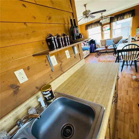 a room with furniture pool table and a large window