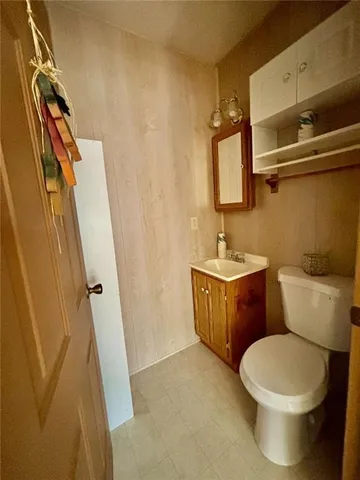 a kitchen with stainless steel appliances granite countertop a sink a stove a refrigerator a washer and dryer