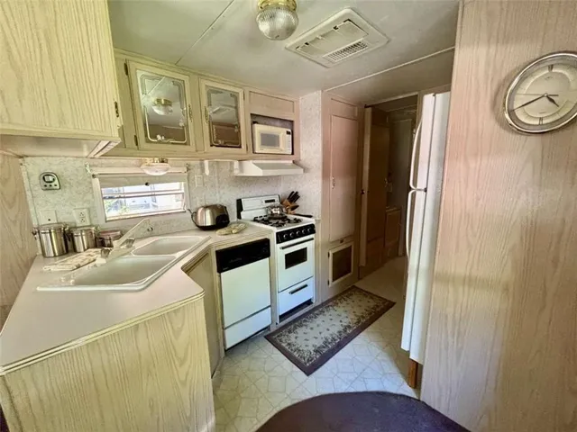 a large bed sitting in a bedroom next to a window