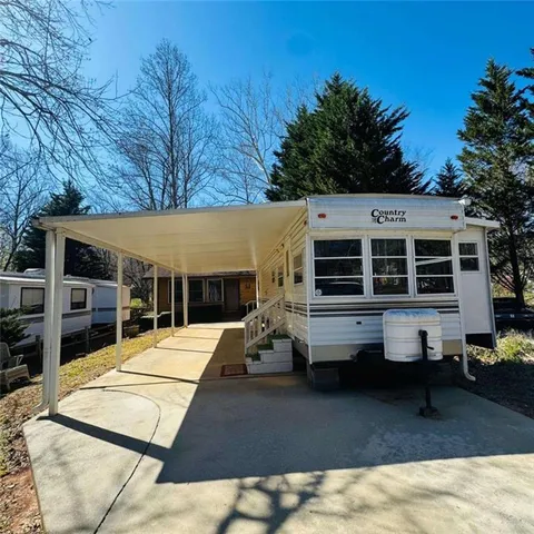 a living room with furniture chess floor and a large window