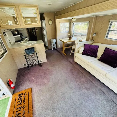 a view of a large white house with a yard