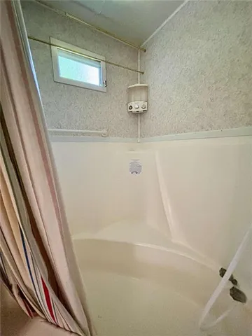 a view of a house with a big yard and sitting area