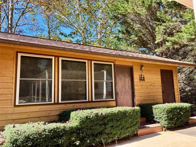 a living room with furniture and floor to ceiling windows