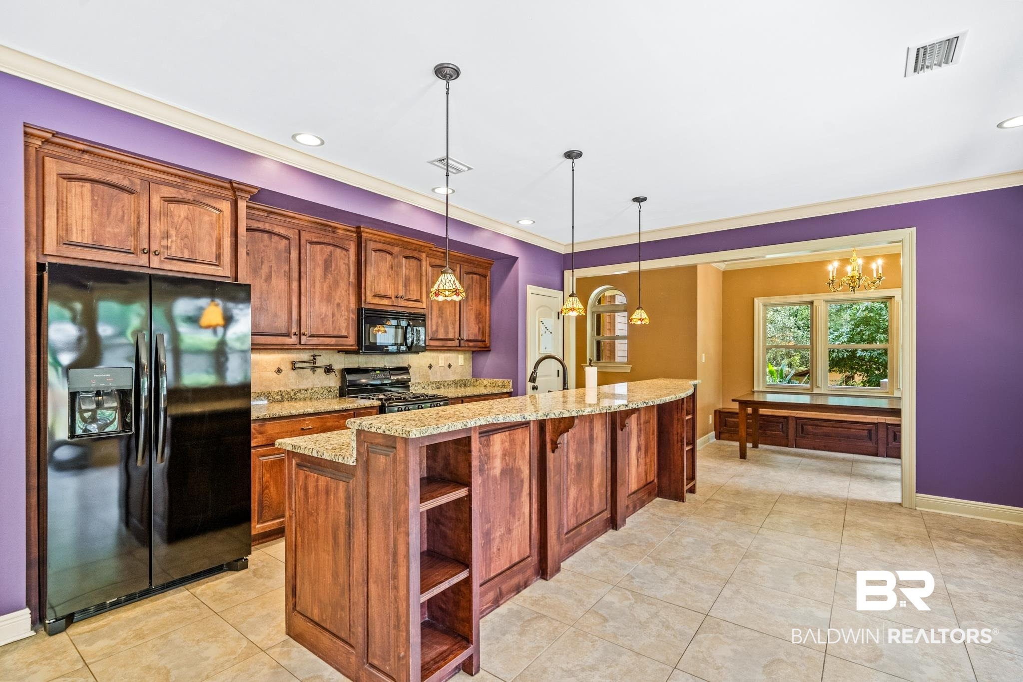 8321 Dixon Road Bay Minette, AL 36507 - Photo 26 of 79 Kitchen featuring light tile patterned floors, pendant lighting, decorative backsplash, a center island with sink, and black appliances