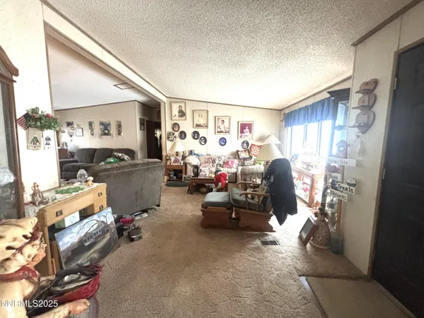 a view of a dining room and livingroom with furniture wooden floor a chandelier