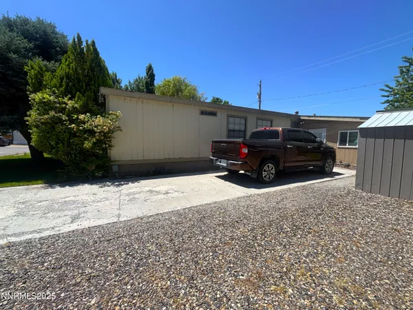 a backyard of a house with barbeque oven table and chairs