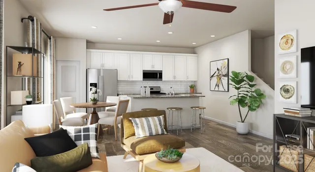 a living room with furniture kitchen view and a large window