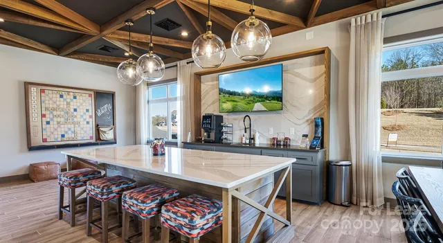 a view of a dining room with furniture a chandelier and wooden floor