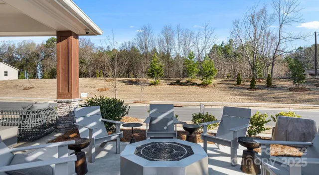 a terrace with outdoor seating and trees