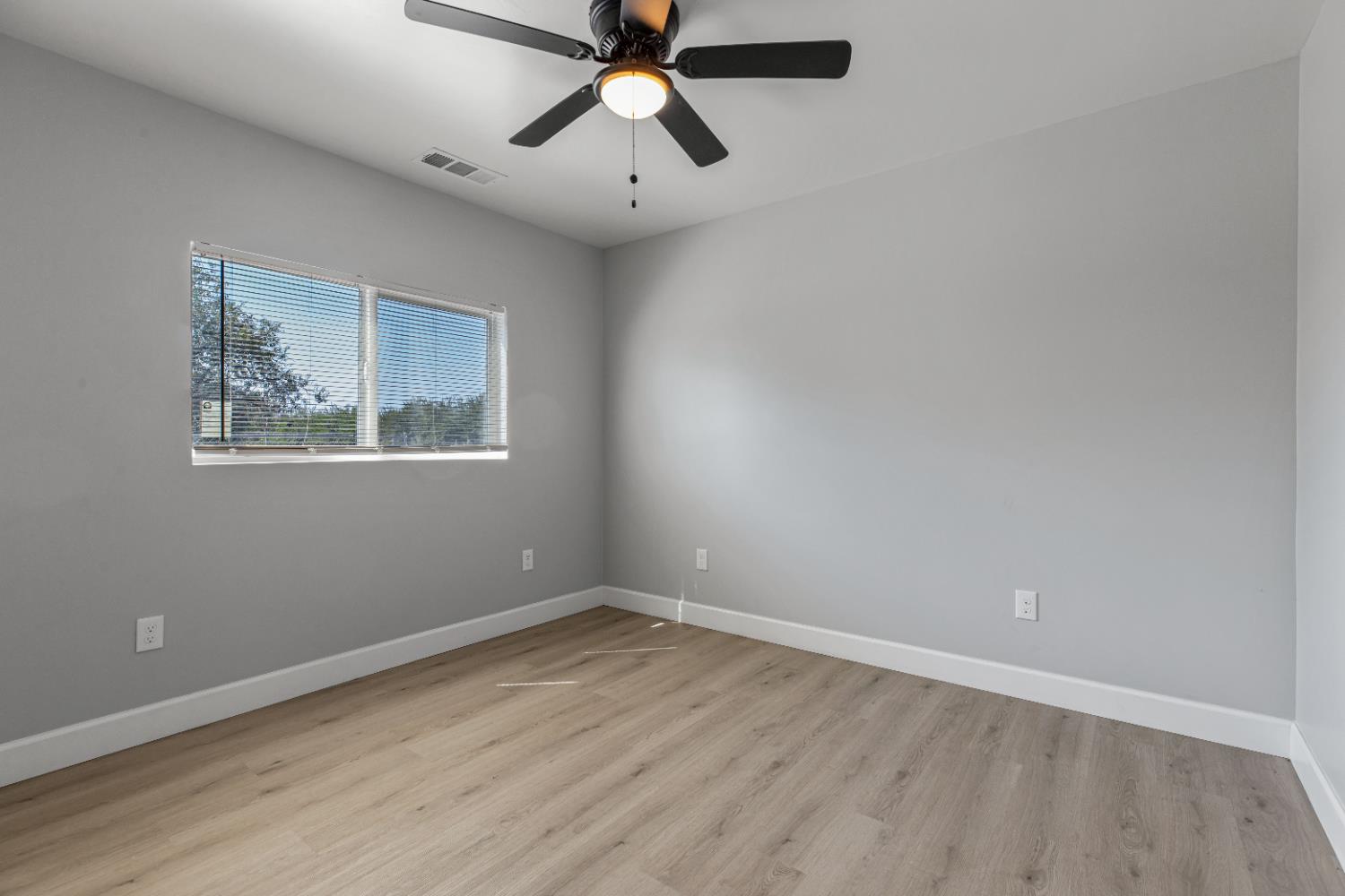 12484 South Union Road Manteca, CA 95336 - Photo 11 of 38 a view of a room with wooden floor and windows