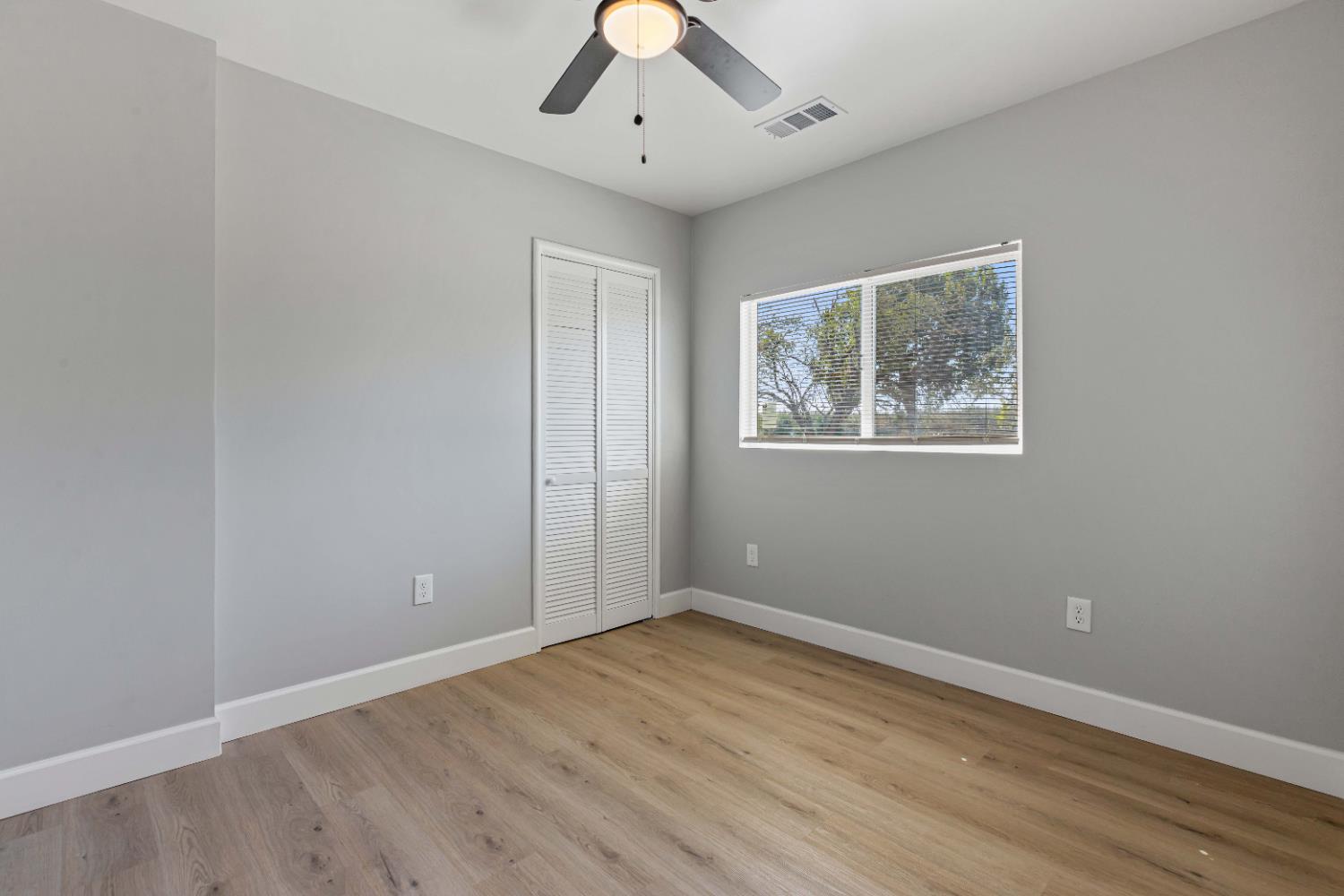 12484 South Union Road Manteca, CA 95336 - Photo 16 of 38 wooden floor in an empty room with a window