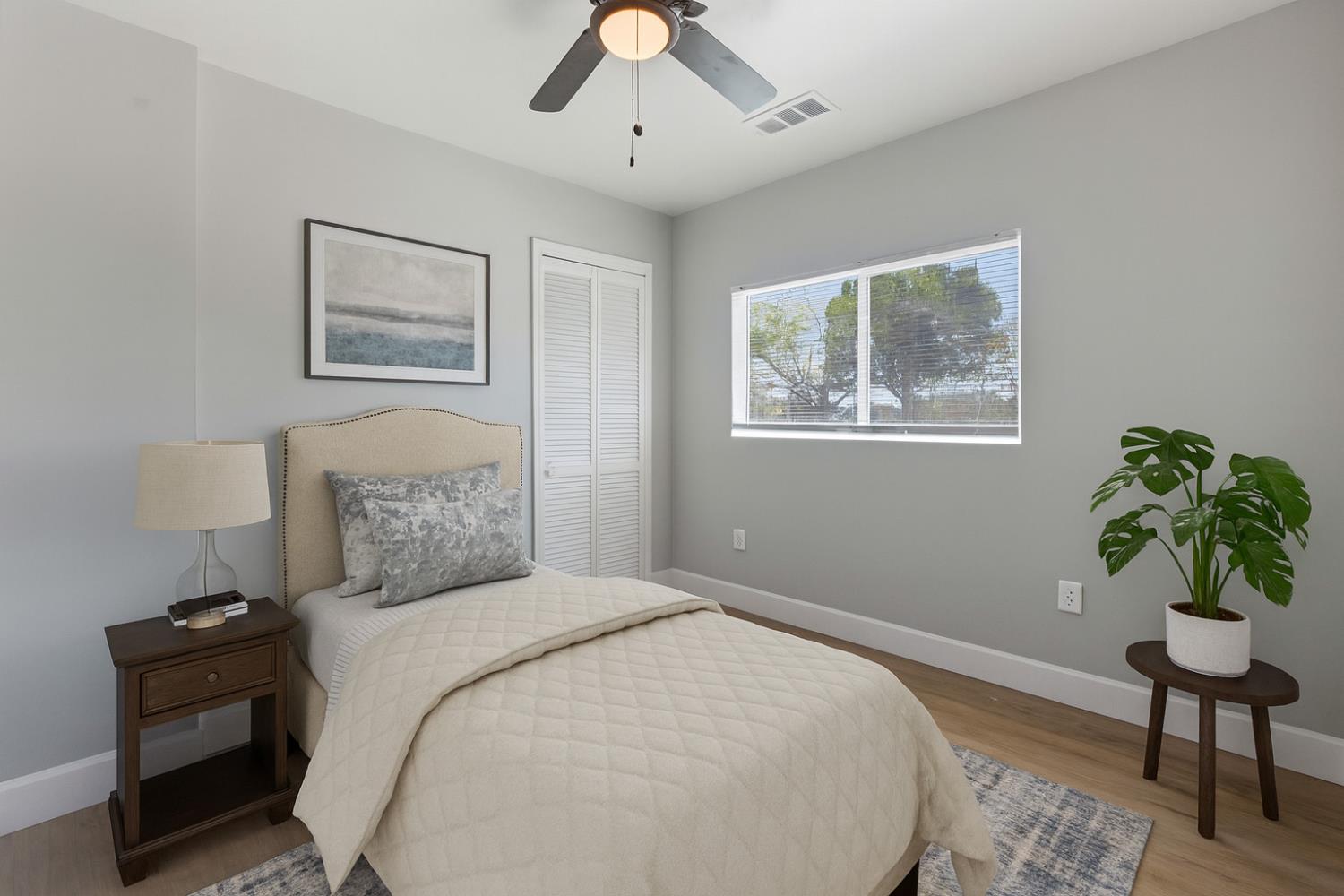 12484 South Union Road Manteca, CA 95336 - Photo 17 of 38 a bedroom with a bed and a potted plant