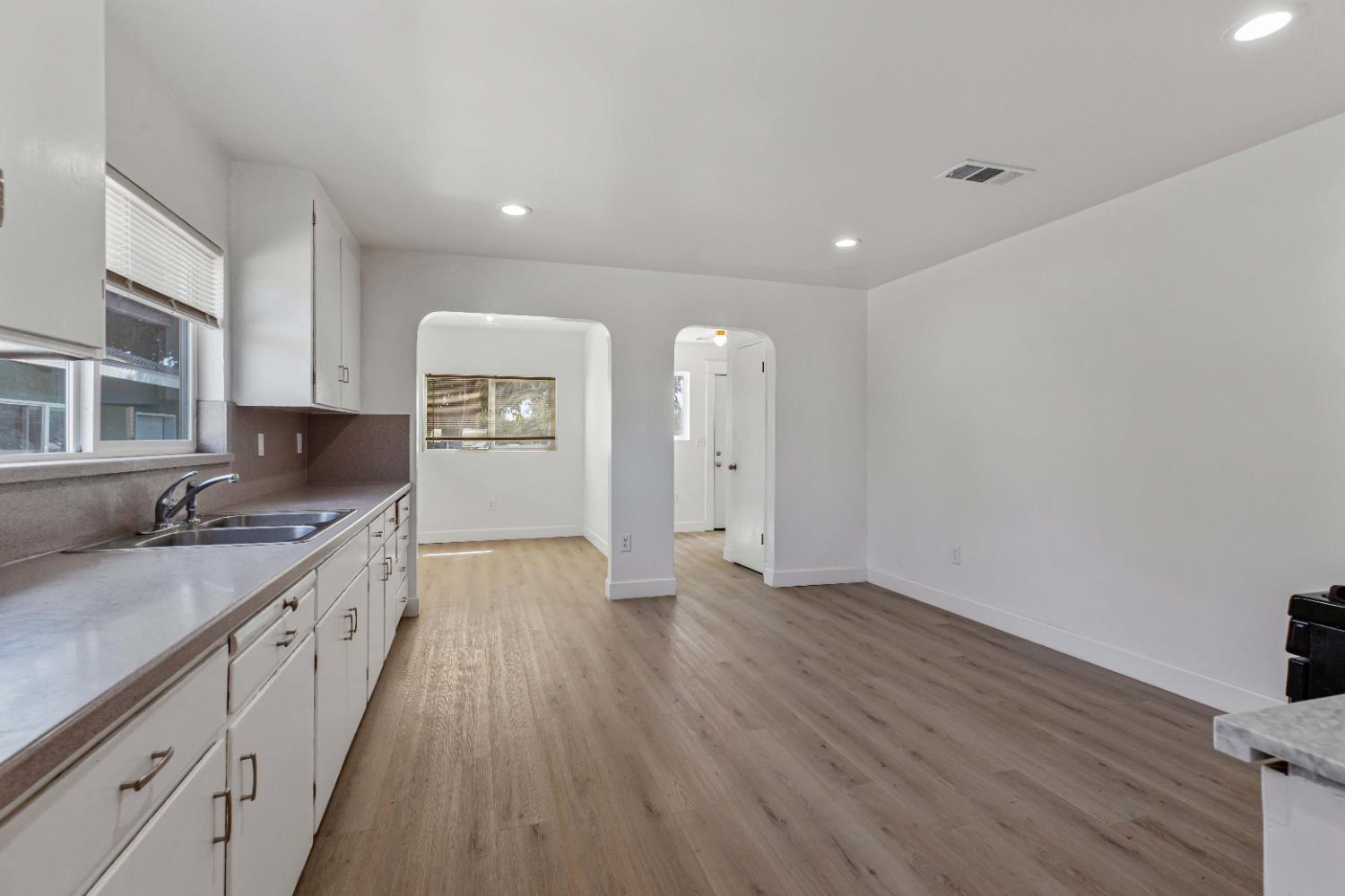 12484 South Union Road Manteca, CA 95336 - Photo 19 of 38 a large kitchen with a sink and wooden floor