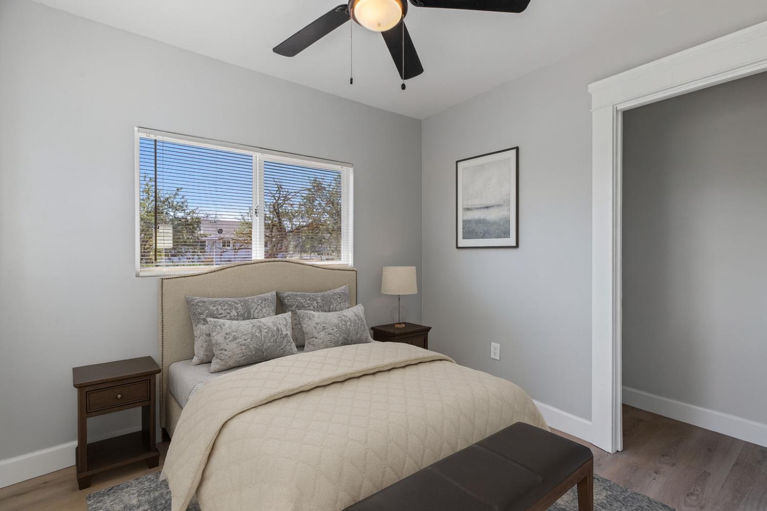 12484 South Union Road Manteca, CA 95336 - Photo 26 of 38 a bedroom with a large bed and a chandelier