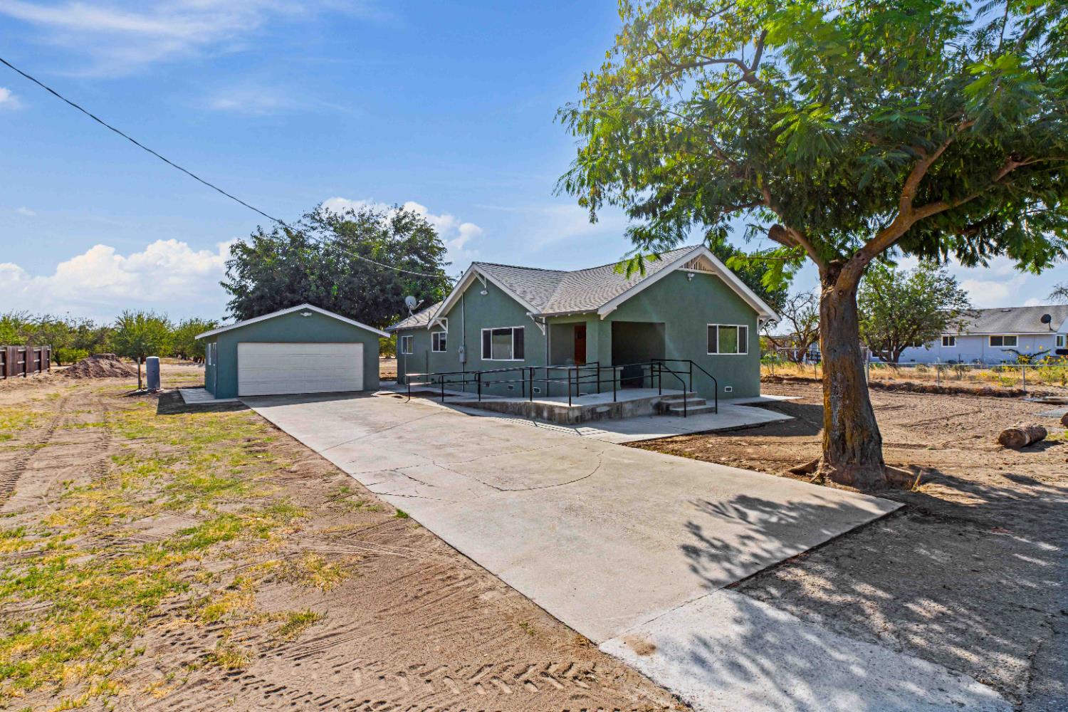 12484 South Union Road Manteca, CA 95336 - Photo 3 of 38 a house with trees in the background