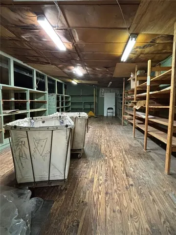 a view of empty room with wooden floor and windows