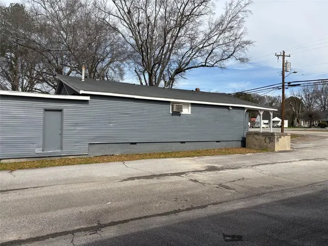 a backyard of a house with lots of trees