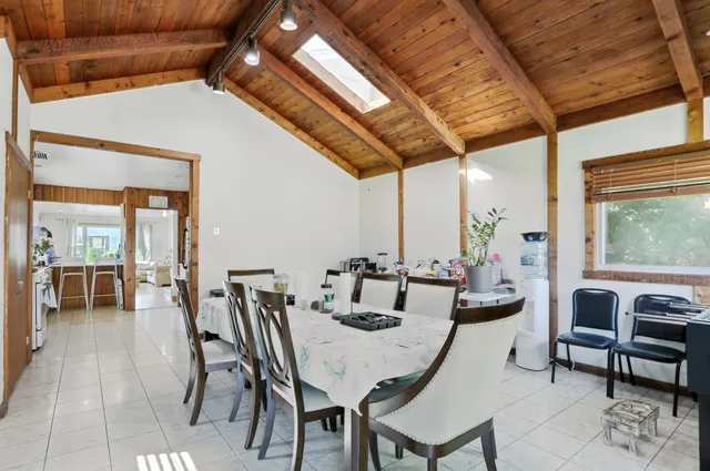 a dining room with furniture and wooden floor