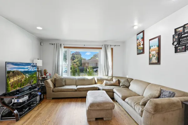 a living room with furniture and a flat screen tv