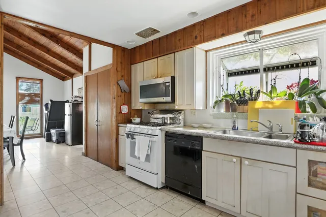 a kitchen with a sink and refrigerator