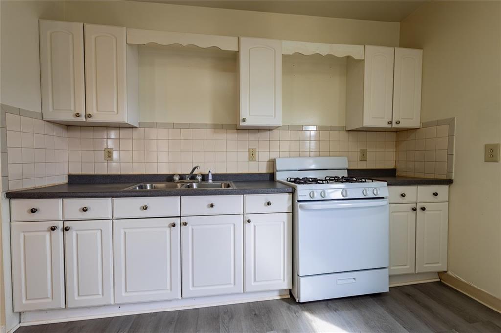 832 Broadway Avenue McKees Rocks, PA 15136 - Photo 11 of 48 a kitchen with white cabinets and white appliances