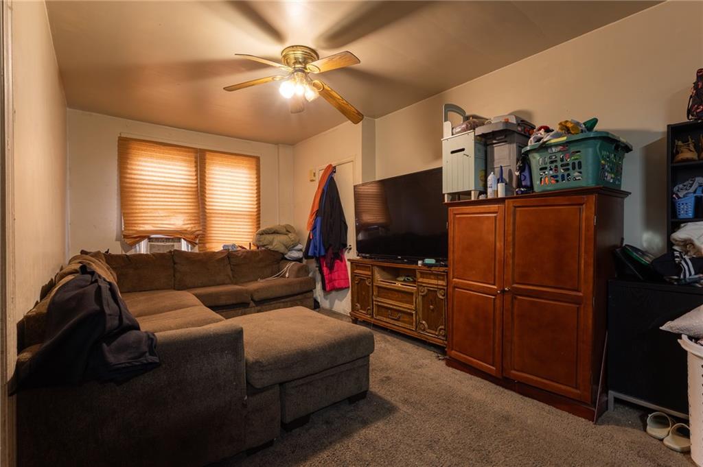 832 Broadway Avenue McKees Rocks, PA 15136 - Photo 15 of 48 a living room with furniture and a flat screen tv