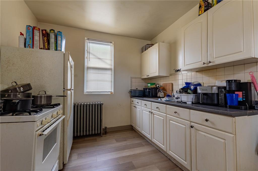 832 Broadway Avenue McKees Rocks, PA 15136 - Photo 28 of 48 a kitchen with stainless steel appliances granite countertop a sink dishwasher stove and white cabinets