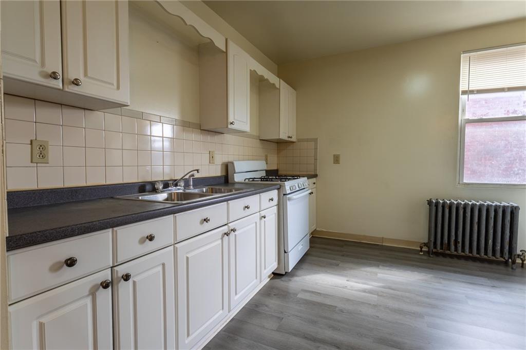 832 Broadway Avenue McKees Rocks, PA 15136 - Photo 4 of 48 a kitchen with granite countertop white cabinets and sink