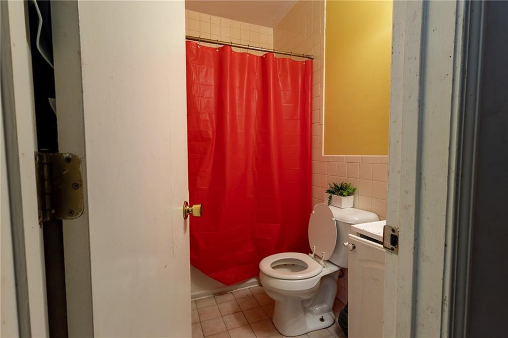 832 Broadway Avenue McKees Rocks, PA 15136 - Photo 42 of 48 a white toilet sitting next to a small window
