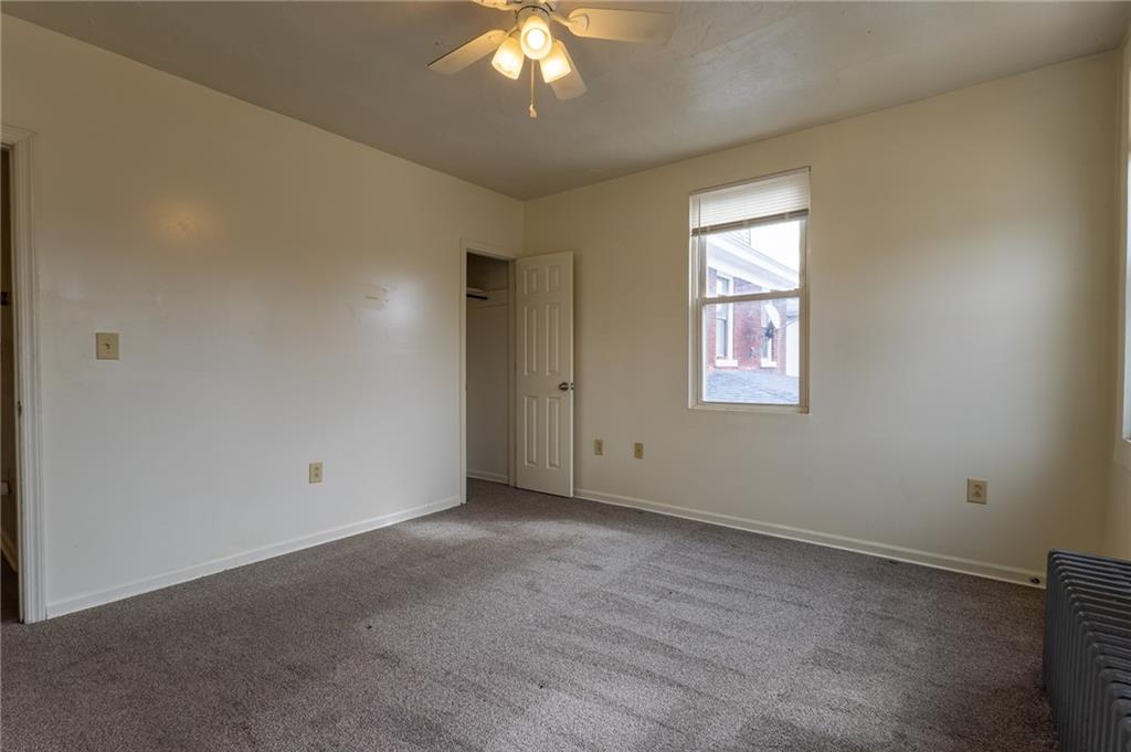832 Broadway Avenue McKees Rocks, PA 15136 - Photo 6 of 48 an empty room with windows and chandelier fan